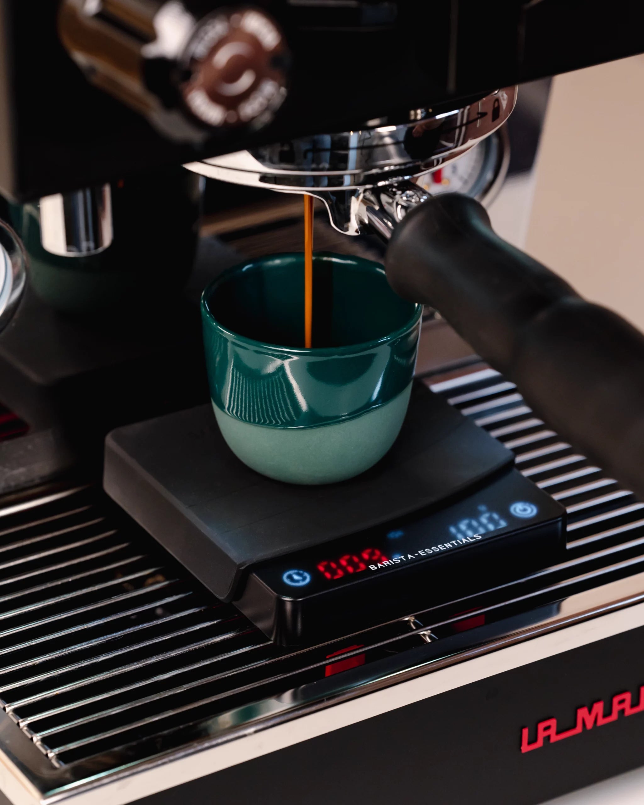 Mini coffee scale on La Marzocco with espresso cup under naked portafilter Barista Essentials
