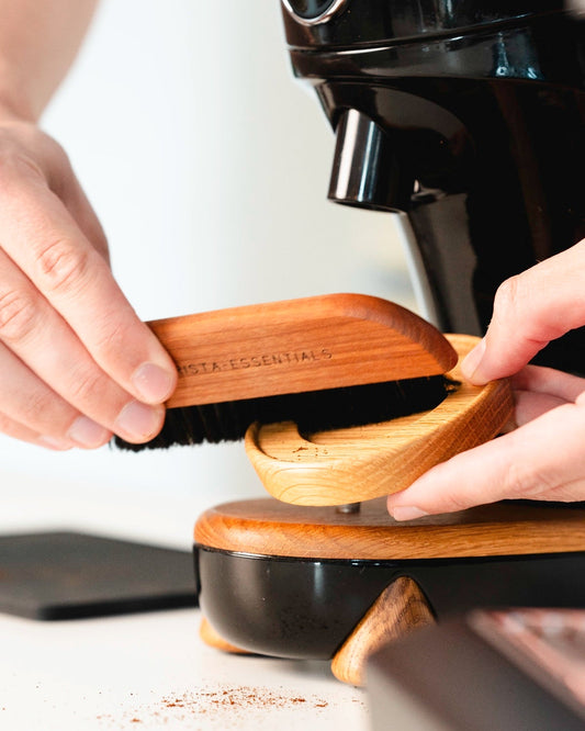 Coffee brush in use to clean around your bean grinder