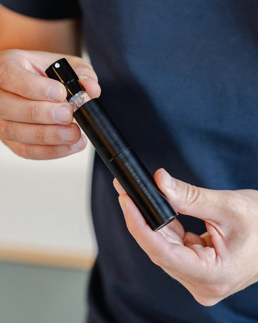 Man pulls glass spray bottle from RDT spray holder by Barista-Essentials